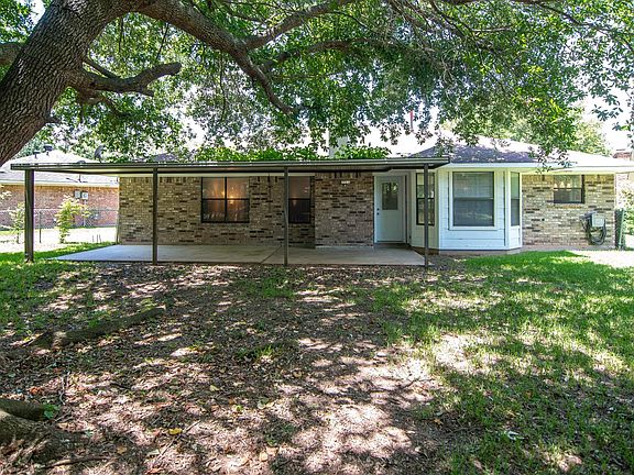 Large shaded back yard with storage shed.
