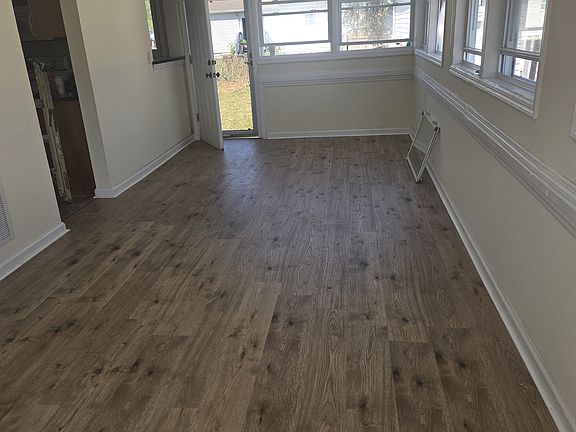 rec room off the kitchen leading to the rear yard, new flooring. recent shot towards backyard
