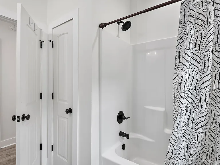Guest bathroom bathtub with linen closet