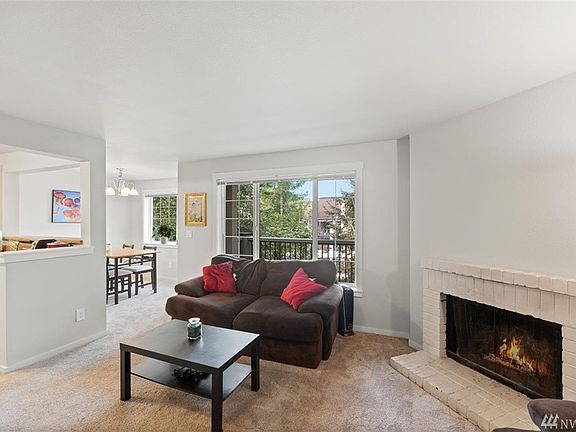 Living room has cozy wood fireplace.  