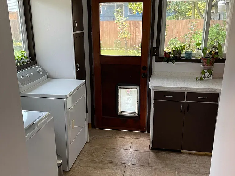 Laundry/mud room with dog door leads to back patio.