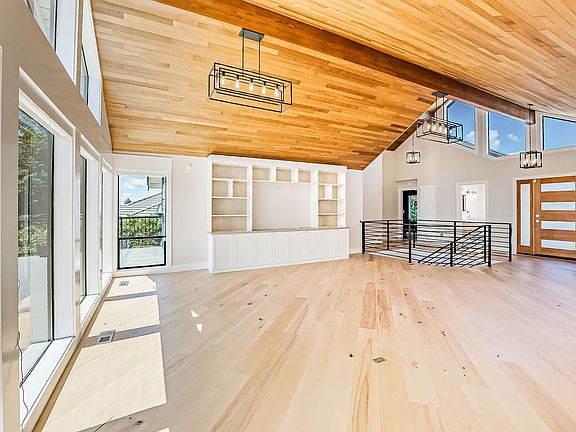 Cathedral Ceilings, Engineered Hardwood Flooring and High End Finishes throughout this home!