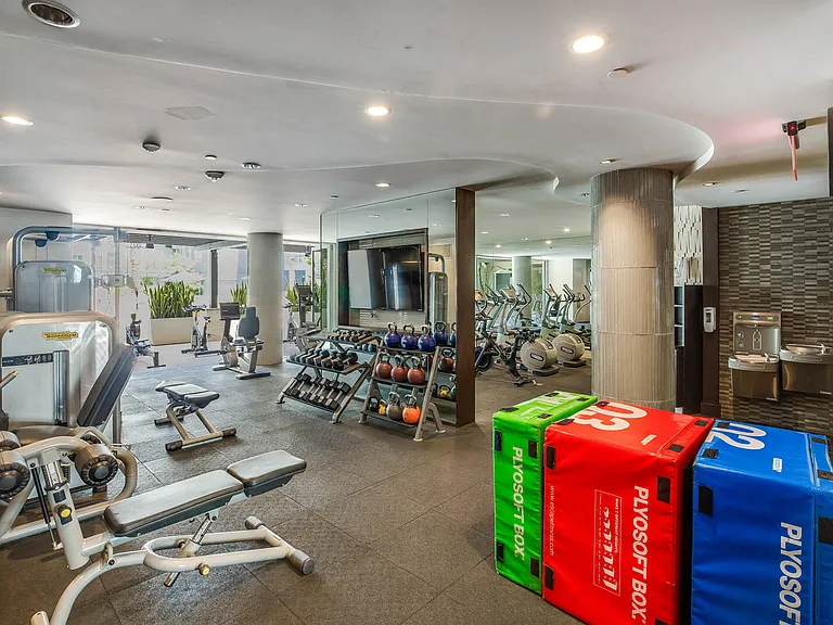 The fitness center is spacious and filled with natural light