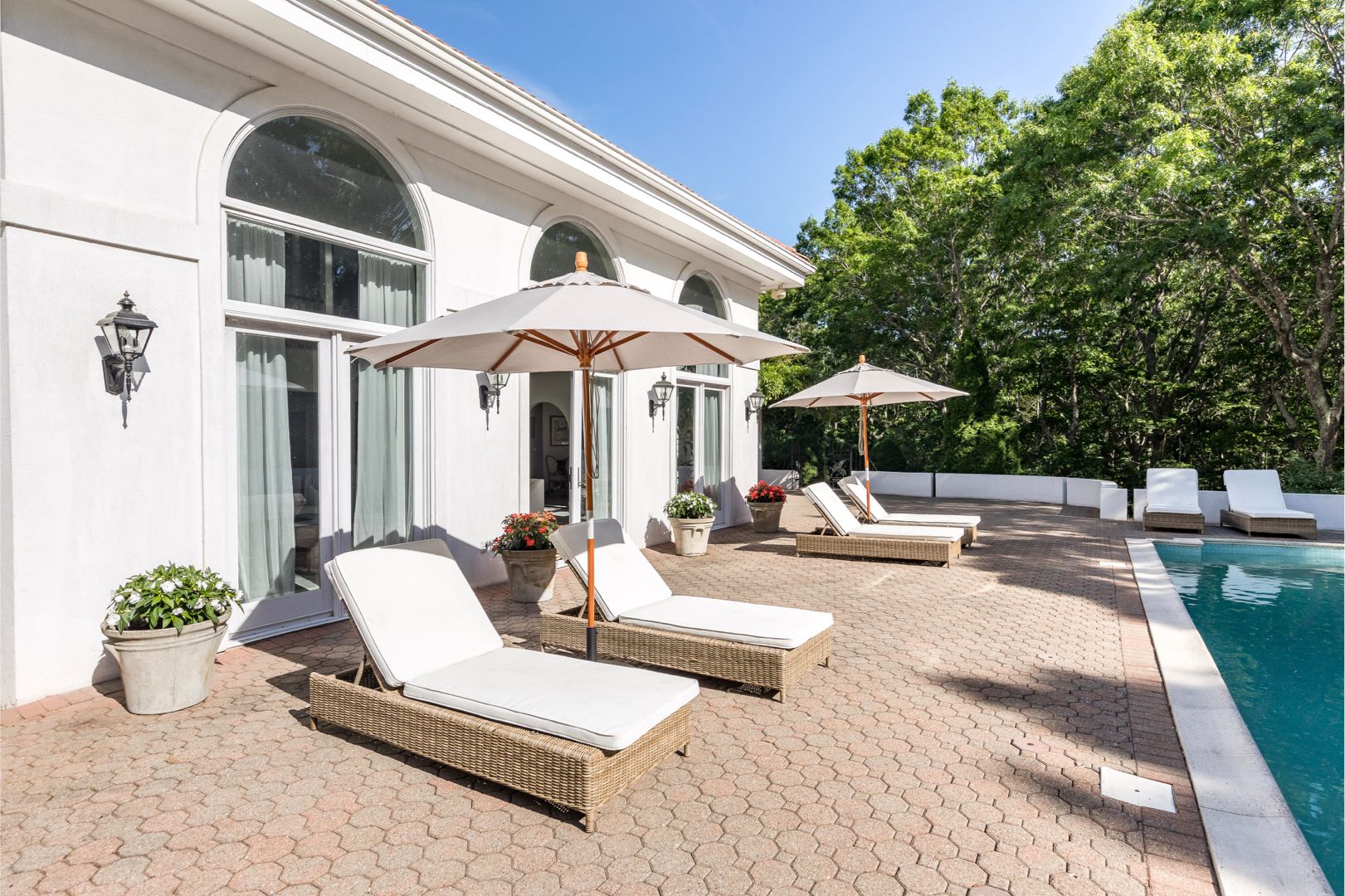  Outdoor space with heated gunite pool, several lounge chairs, a grill, pergola for outdoor dining.