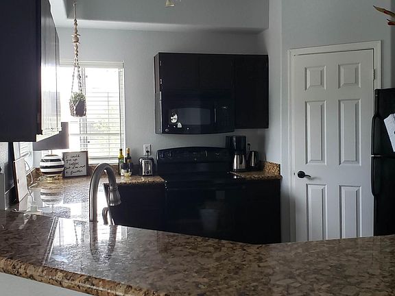 Updated kitchen includes granite countertops, walk-in pantry, updated appliances. Glasses, plates, and basic cookery included.