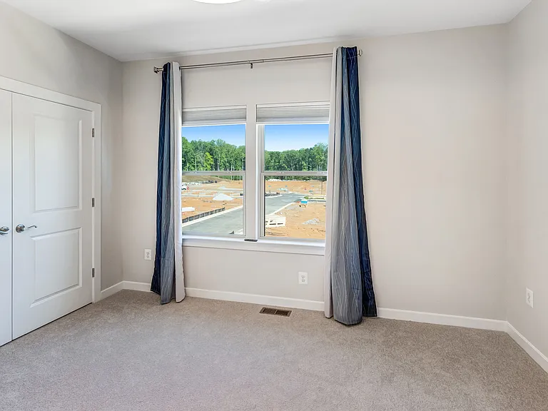 Bright and versatile secondary bedroom with generous closet space and plenty of natural light.