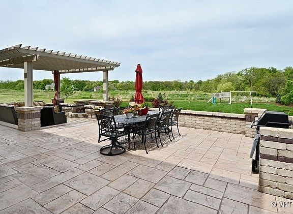 Enjoy Relaxing spacious Stamped Concrete Patio with Cedar Pergola.