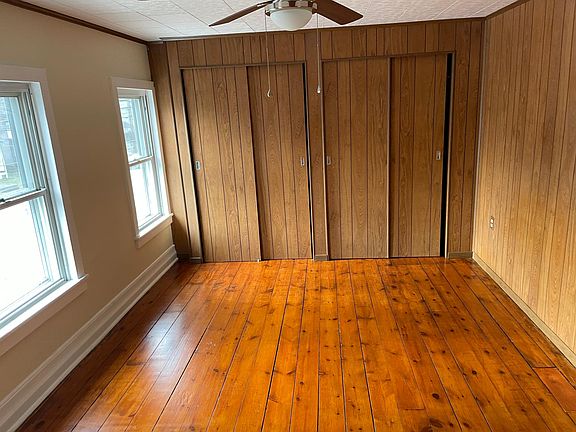Master bedroom with plenty of closet space, wood floors