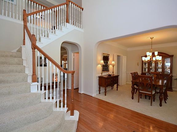 An entry with rounded corners opens to the formal dining room. A wonderful place for gathering with 