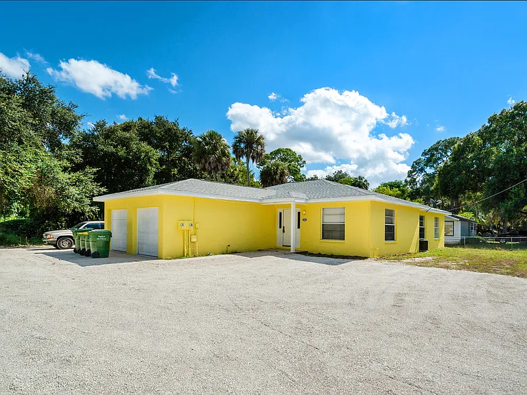 Front side. Attached garage, yard to the right, & plenty of parking.