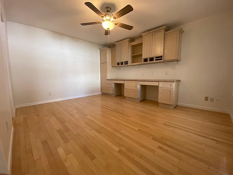 second bedroom with built in office cabinetry/desk