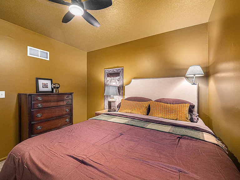 A thoughtfully designed bedroom with a distinctive style, offering a cozy and welcoming atmosphere with plenty of personality.