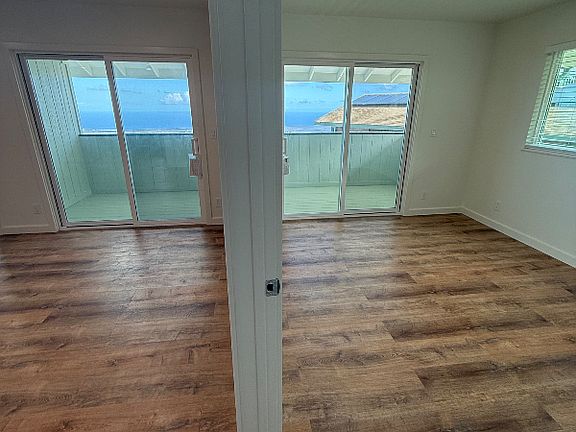 Living room and makai bedroom, both with access to lanai and incredible views