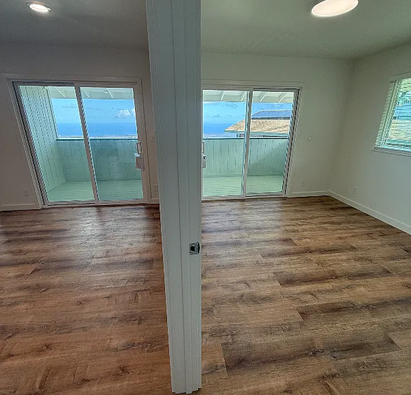 Living room and makai bedroom, both with access to lanai and incredible views