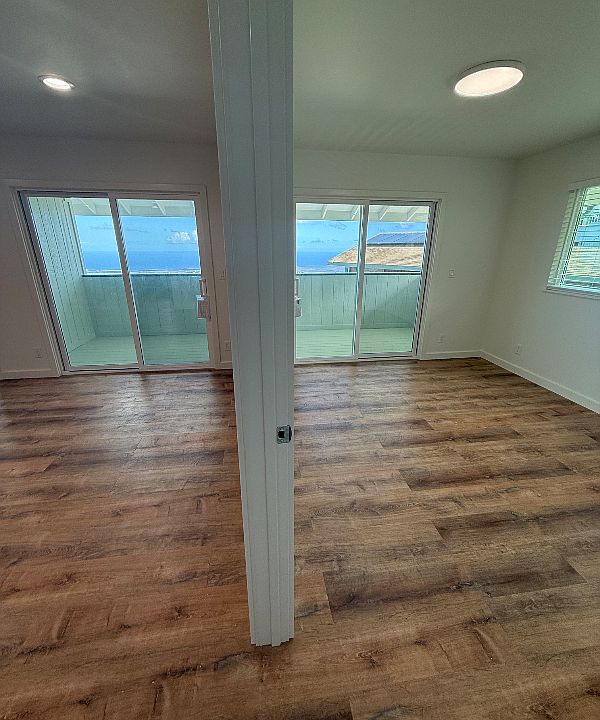 Living room and makai bedroom, both with access to lanai and incredible views