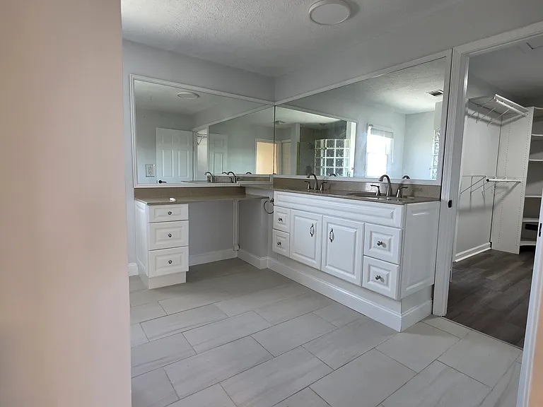 Master bath with custom cabinetry and 2 sinks