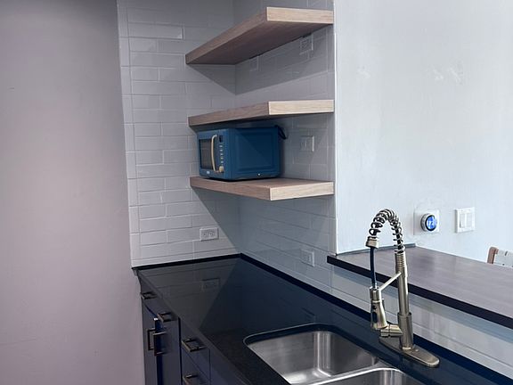 Open kitchen with breakfast bar and stainless steel appliances