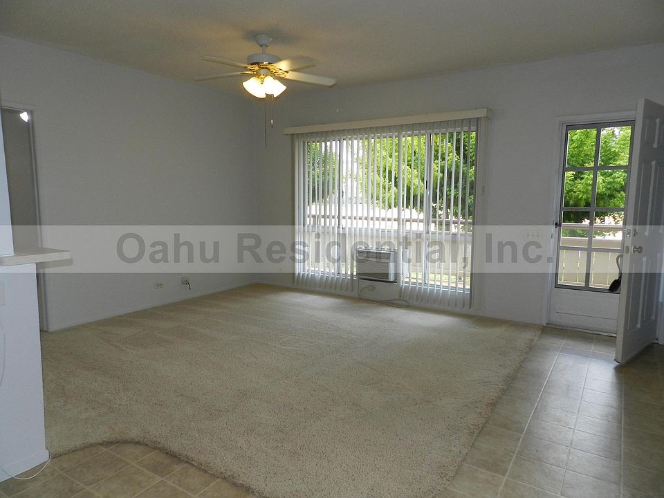 Living room from dining area, facing large full-length lanai