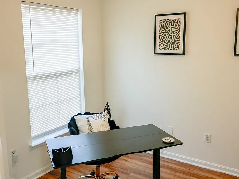 Versatile room ideal for a home office, study, or additional bedroom_featuring beautiful hardwood flooring and abundant natural light.