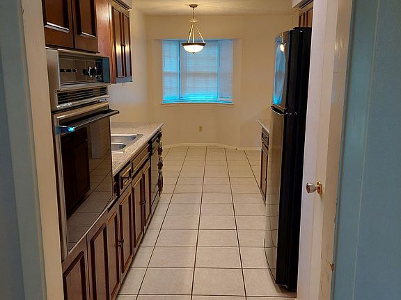 Kitchen view from living room to bay window in breakfast area