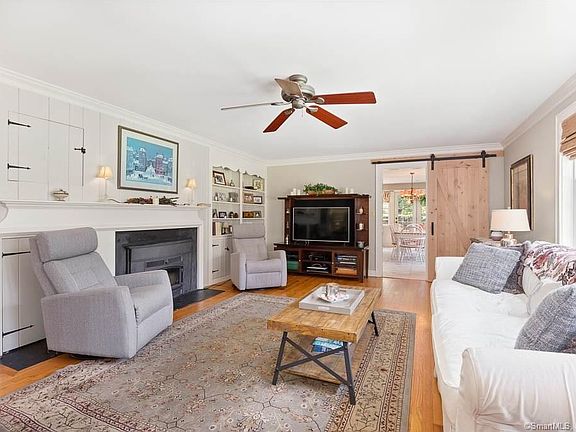 Living room with barn door leading into the kitchen