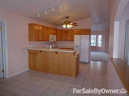 Kitchen view
						:
						Shows an end view of the kitchen, Corian countertops w/brkfast bar & appliances.