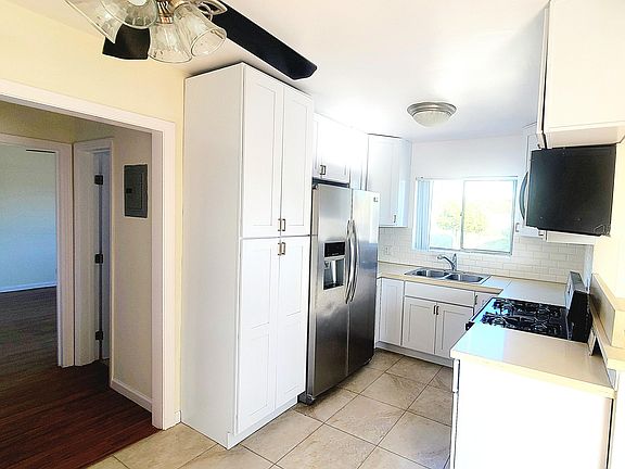 Stainless steel appliances and contemporary custom cabinets