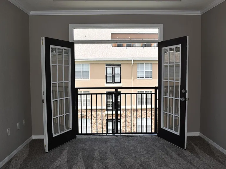 French doors in the Living room overlook the pool.