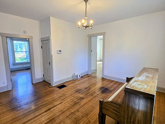 Step into the living area (piano not included) with original hardwood floors