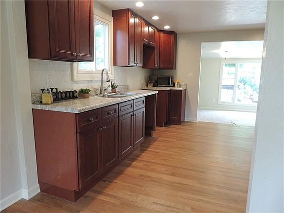 This kitchen isn't just new to you, it's brand new.  Recently renovated to make more room and all new cabinets, counter tops, fi