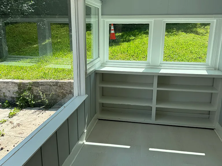 Rear sunporch with big glass windows.