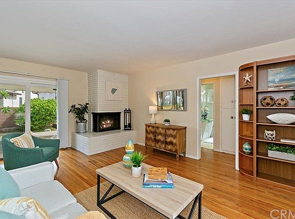 Enjoy the inviting fireplace!  Home is ready for you to move right in!  Bookcase on right hand side included in sale.