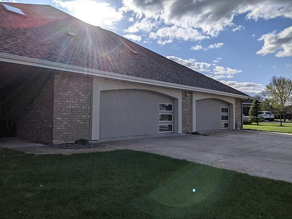 Heated 4-stall workshop/garage can be used for additional parking, projects, and tons of storage
