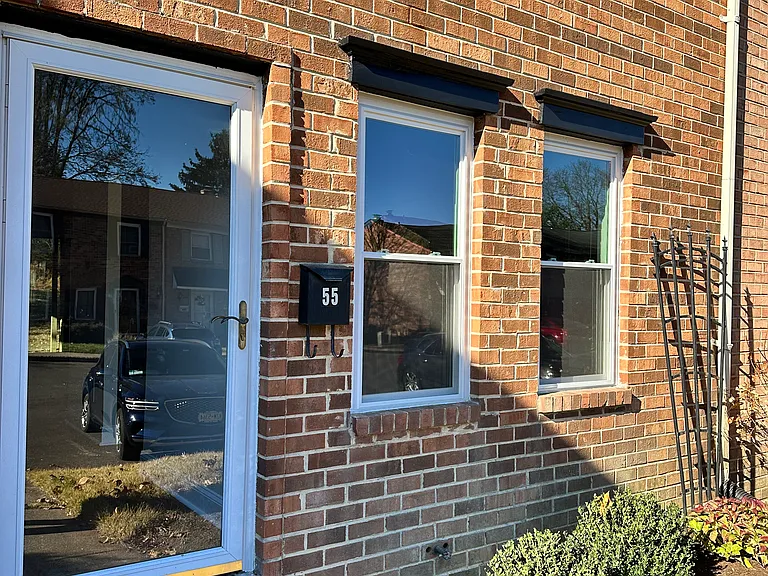 Welcoming front entrance with a neatly manicured mini garden, adding curb appeal and charm.