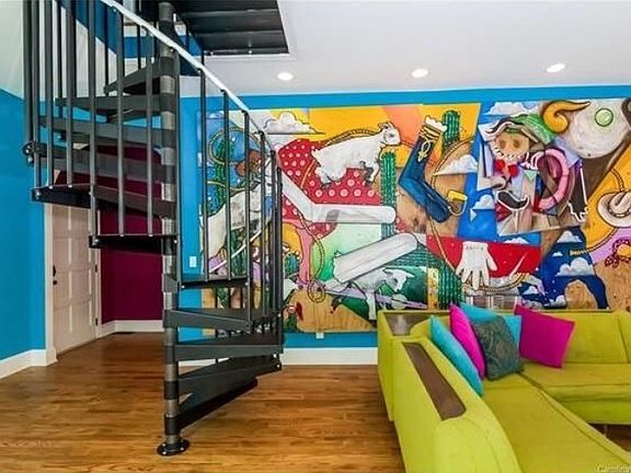 Spiral stairs lead to a private study or small loft.