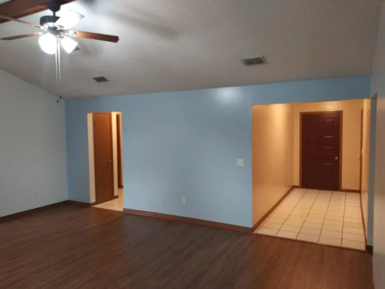 Great room view of entryway and guest bed/bath hallway.