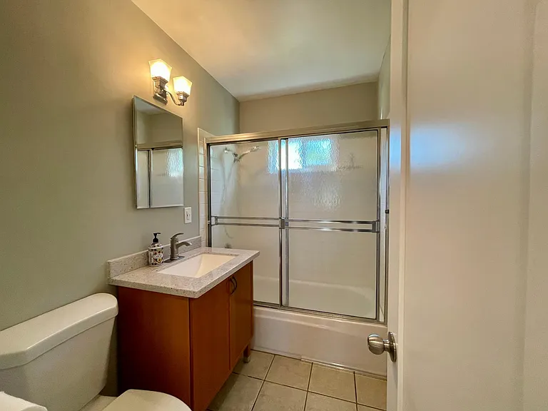 Bathroom with vanity cabinet storage.