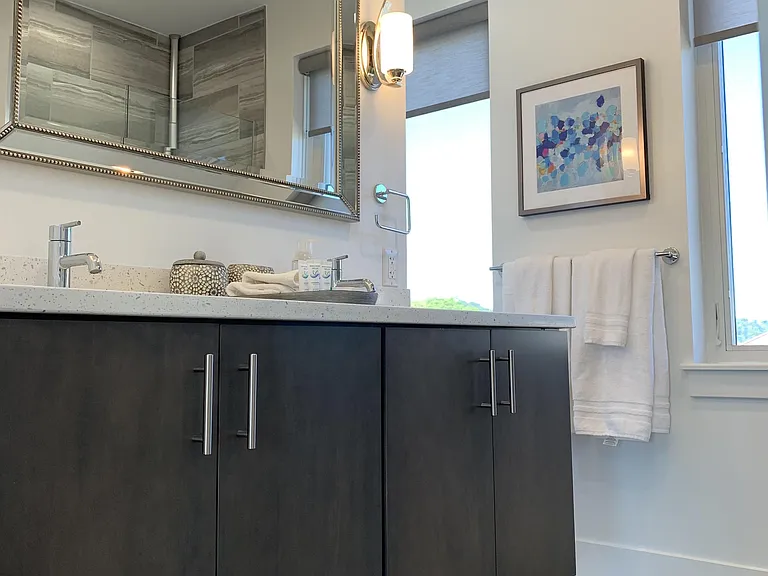 The master bathroom is spacious, stylish, and well equipped.