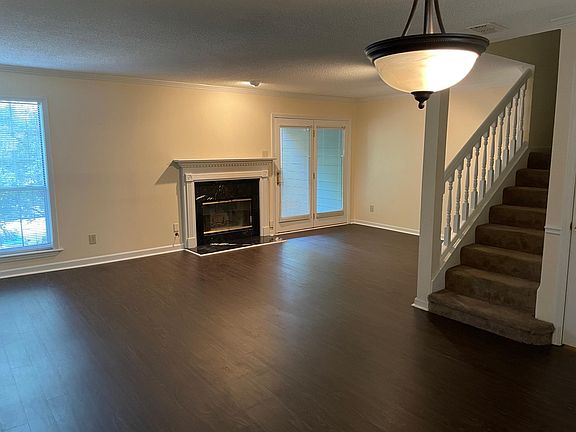 Living room with fireplace and door to balcony.
