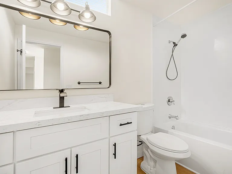 An additional newly remodeled modern bathroom with a stylish design and a comfortable bathtub for soaking.