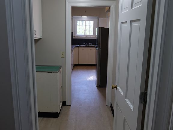 Laundry room leading into kitchen. Hook ups available, but washer and dryer not included.