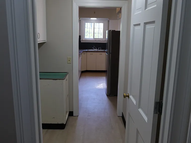 Laundry room leading into kitchen. Hook ups available, but washer and dryer not included.