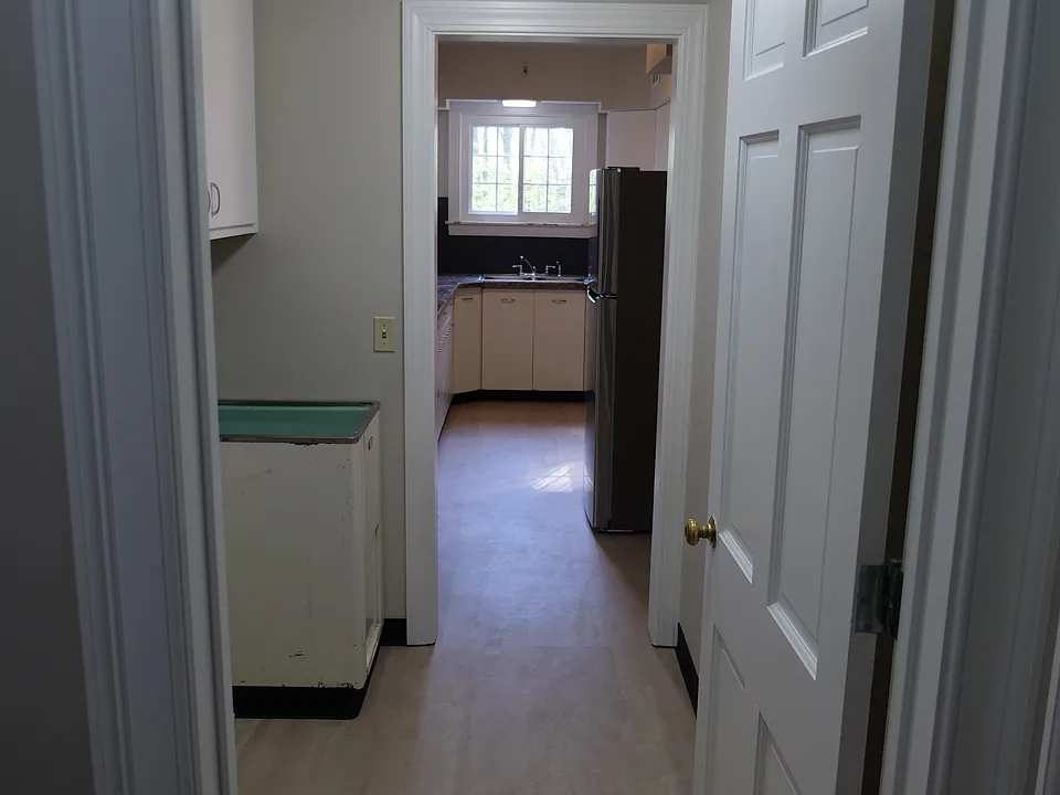 Laundry room leading into kitchen. Hook ups available, but washer and dryer not included.