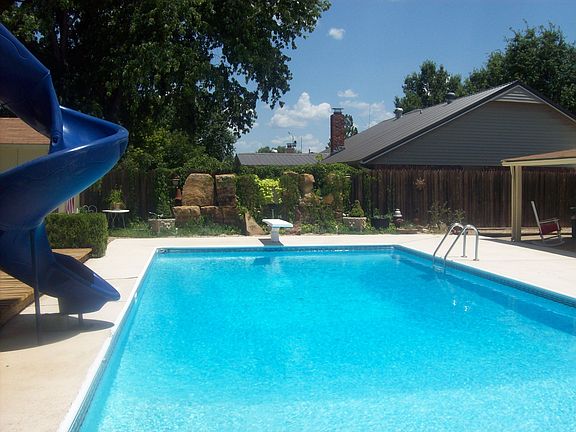 In-ground pool complete with slide and diving board
