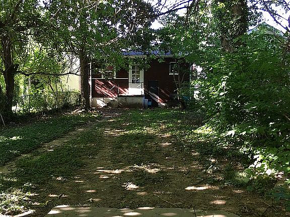 Fenced back yard-alley view