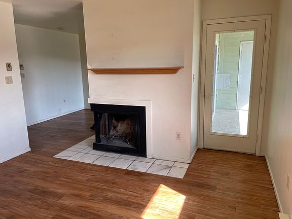 Living room with wood burning fire place.