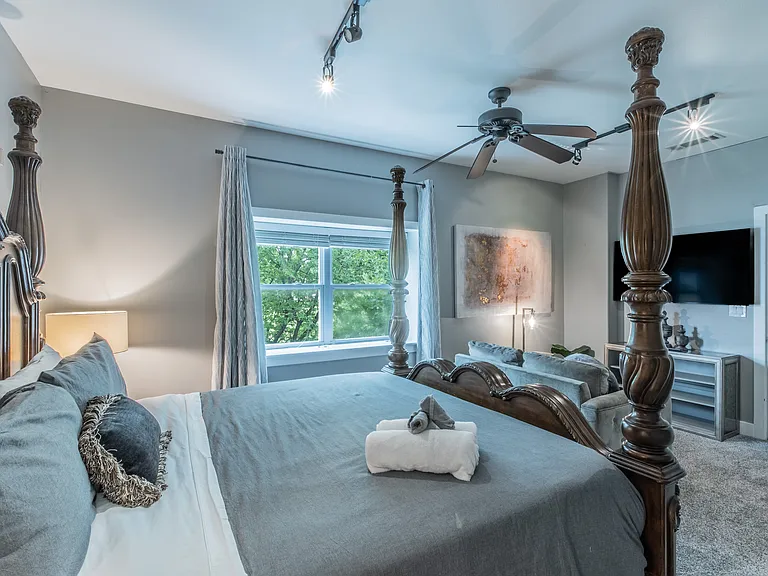 A spacious retreat featuring a grand bed and cozy seating.