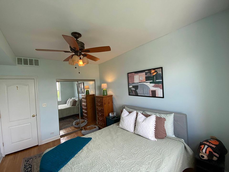 Master bedroom w/ fan, blackout shade, and mirrored closet door (previous listing)