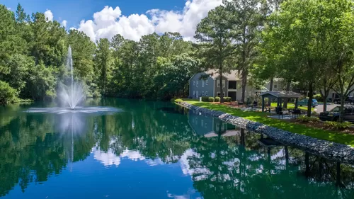 Serene waters, a central fountain, and lush green surroundings create a peaceful oasis right in the heart of the community. - Emerson Isles