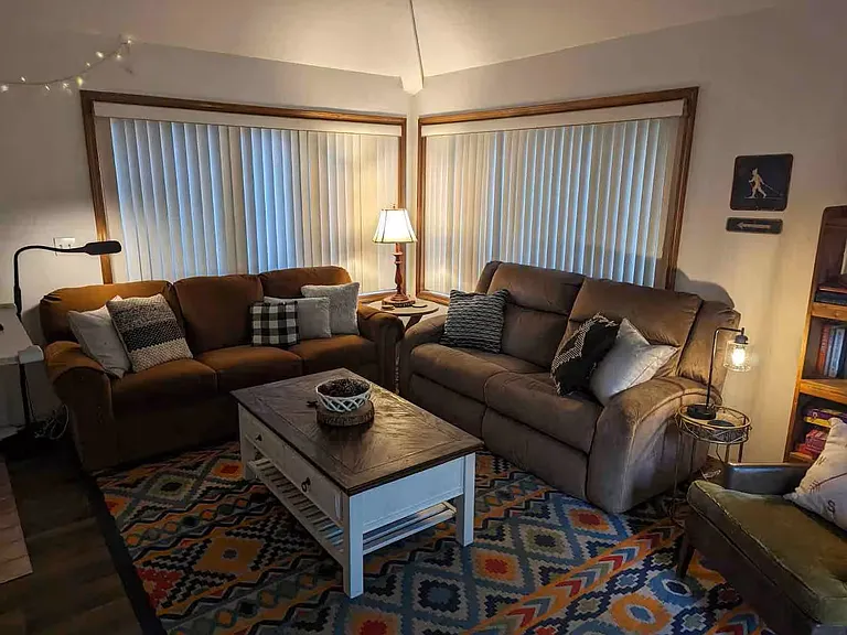 Living room with pullout bed (left), dual reclining couch (right)